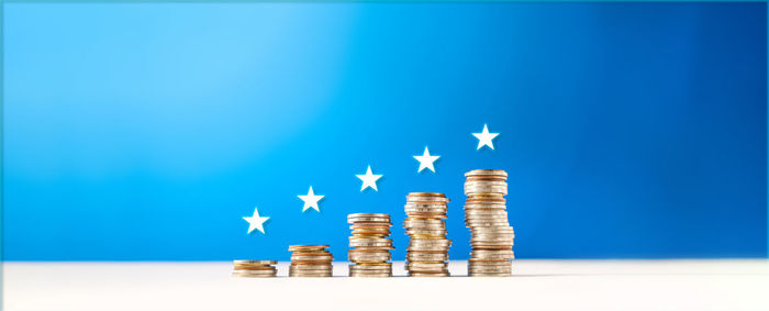 Close-up of coins on table against blue background