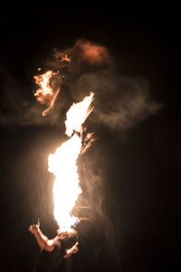 Silhouette woman against illuminated sky at night