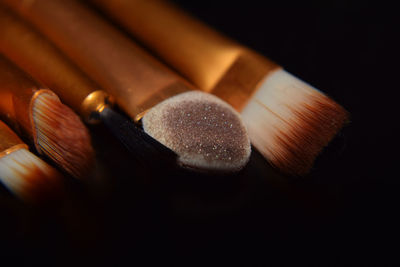 Close-up of make-up brush on black background