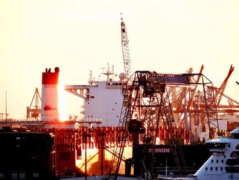 Cranes at construction site against sky