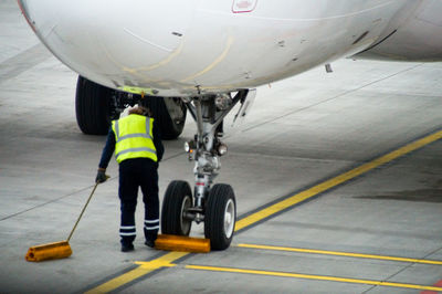 Midsection of man on airplane at airport