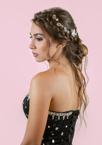 Portrait of smiling young woman against white background