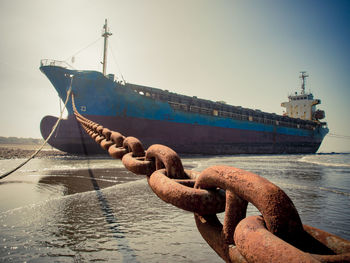 Ship moored in sea against sky