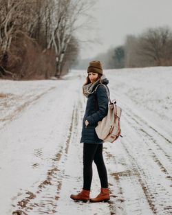 Full length portrait of man standing in snow