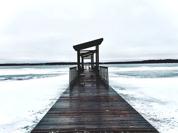 Pier over sea against sky