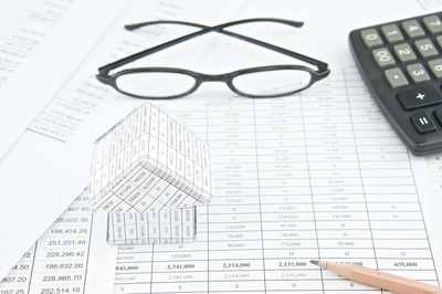 High angle view of eyeglasses and calculator on financial documents