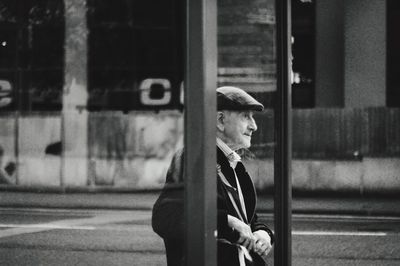 Side view of man standing on road