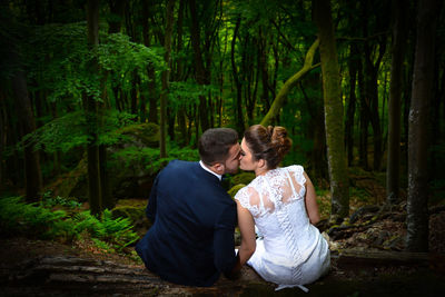 Couple sitting in forest