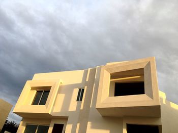 Low angle view of building against cloudy sky