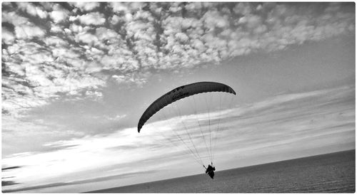 Low angle view of parachute flying in sky