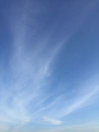 Low angle view of vapor trail in blue sky