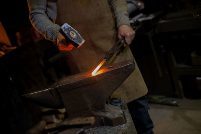 The hands of a blacksmith at work in the smithy