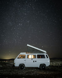 Camper van on field at night