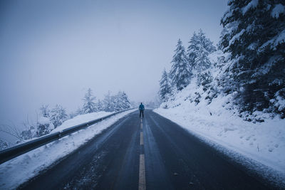 Man standing on road snow covered 