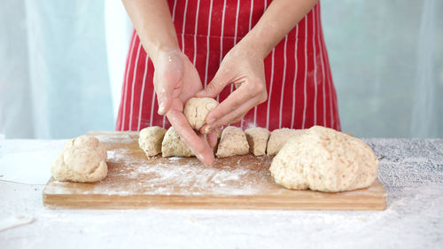 Midsection of woman preparing food on table