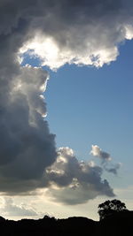 Scenic view of silhouette mountains against cloudy sky