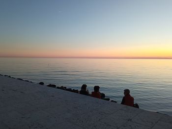 Scenic view of sea against clear sky during sunset