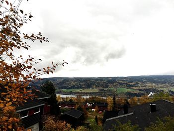 View of cityscape against cloudy sky