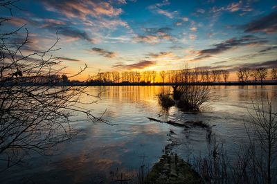 Scenic view of lake against orange sky