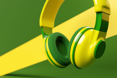 Close-up of yellow toy over green background