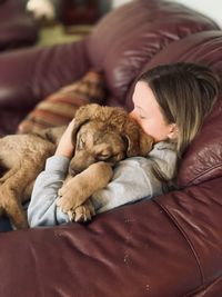 High angle view of teenager with dog at home