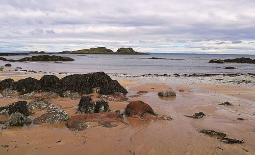 View of beach against cloudy sky