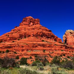 Low angle view of mountain against blue sky