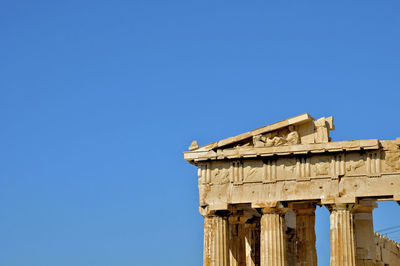 Cropped image of parthenon against clear blue sky on sunny day