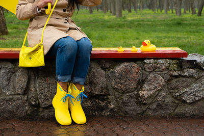 Stress resilience and mental health, no depression concept. womens legs in yellow rubber boots and