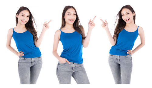 Portrait of a smiling young woman against white background