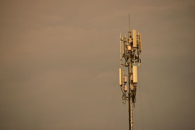 Communications tower against sky during sunset