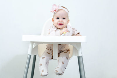 Portrait of boy playing with toy against white background