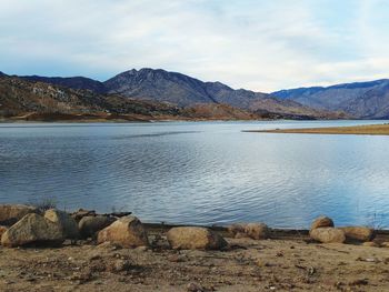 Scenic view of lake against cloudy sky