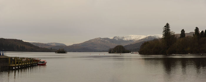 Scenic view of lake and mountains against clear sky