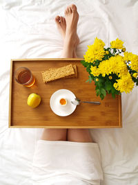 High angle view of woman lying on bed