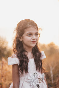 Little girl making funny faces during a sunset