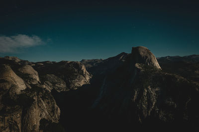 Low angle view of rock formation against sky at night