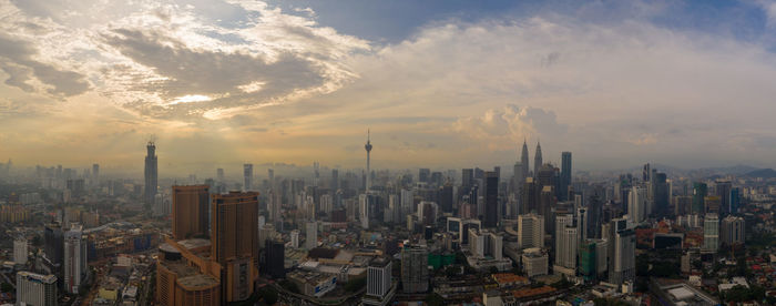 Aerial view of modern buildings in city against sky