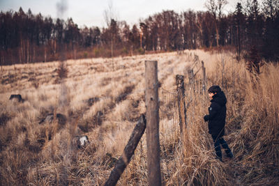 Side view of man standing on field