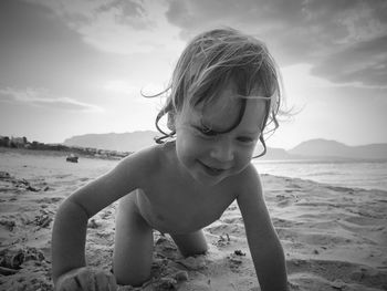 Portrait of boy on beach against sky