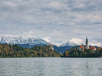 View of the snow-capped mountain peaks against the lake bled.