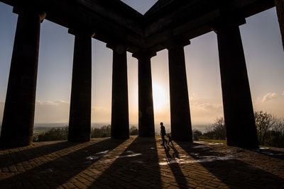 Silhouette columns against sky during sunset