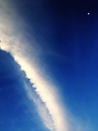 Low angle view of vapor trail in blue sky