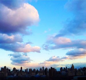 Cityscape against cloudy sky