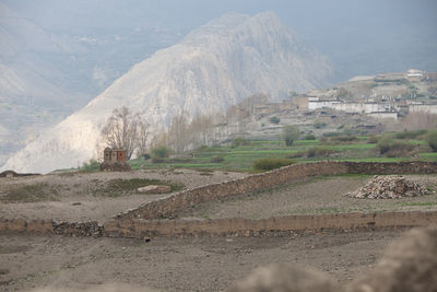 Scenic view of land and mountains against sky