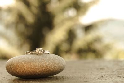 Close-up of engagement ring on table with rock 