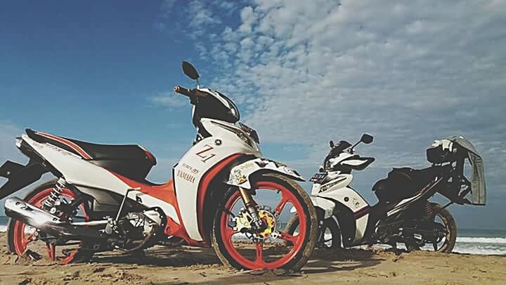 sky, bicycle, transportation, land vehicle, mode of transport, stationary, parking, beach, cloud - sky, outdoors, parked, no people, cloud, day, sunlight, sand, blue, sea, nature, shadow