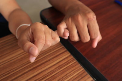 Midsection of person playing piano on table