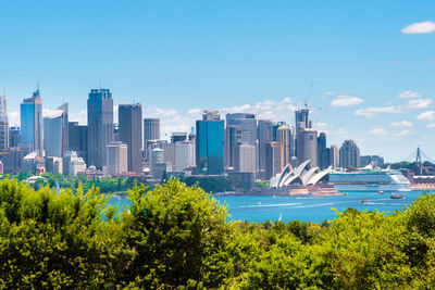 Scenic view of trees and buildings against sky