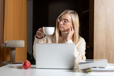 Man drinking coffee cup on table